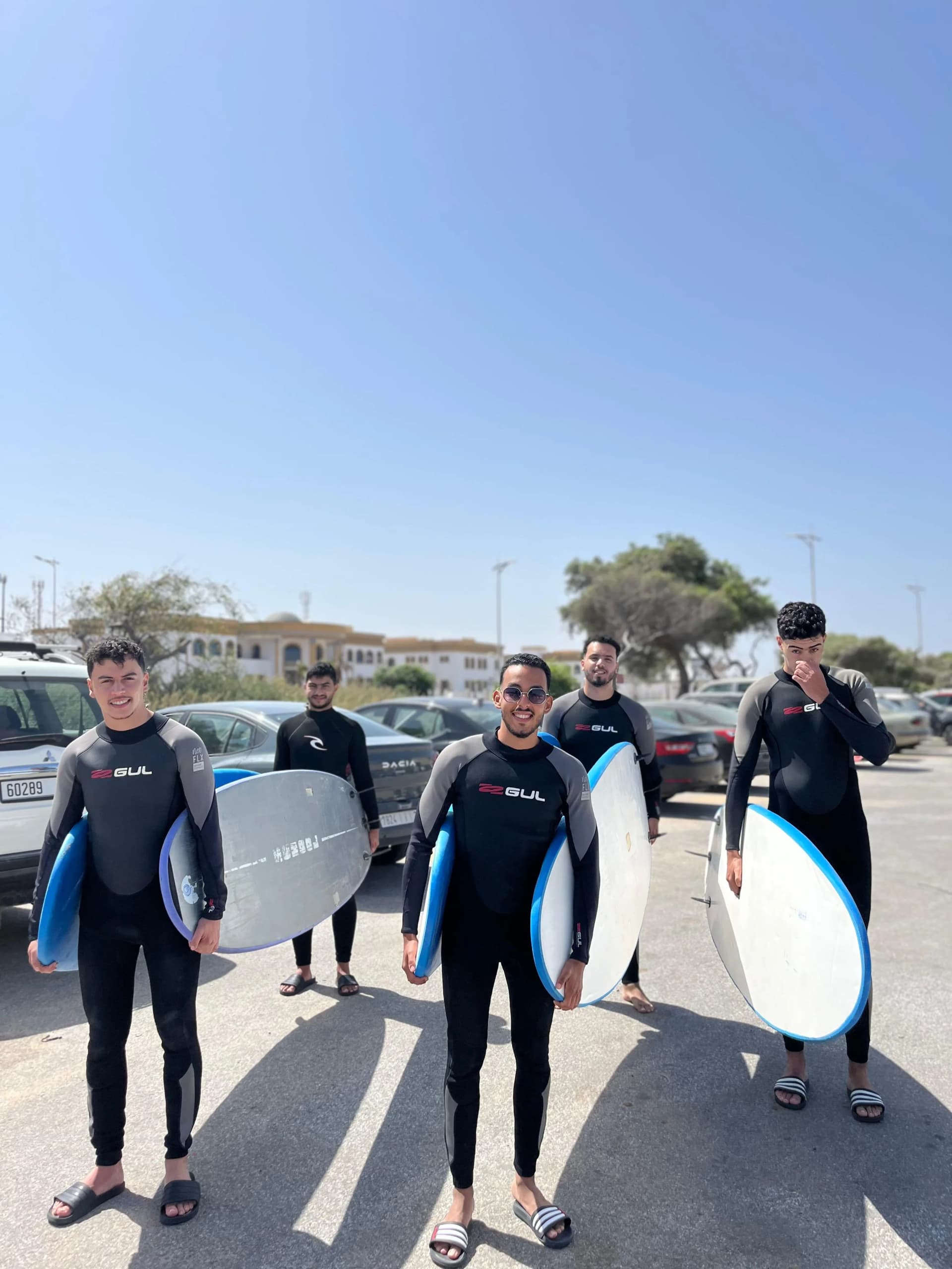 Surf camp group with boards on SUV roof rack, Essaouira surf trip departure