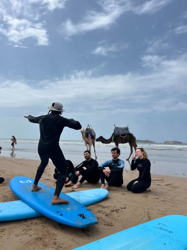 Beginner surf lesson on the beach, Essaouira, IKO-certified instructor with soft-top board, Morocco